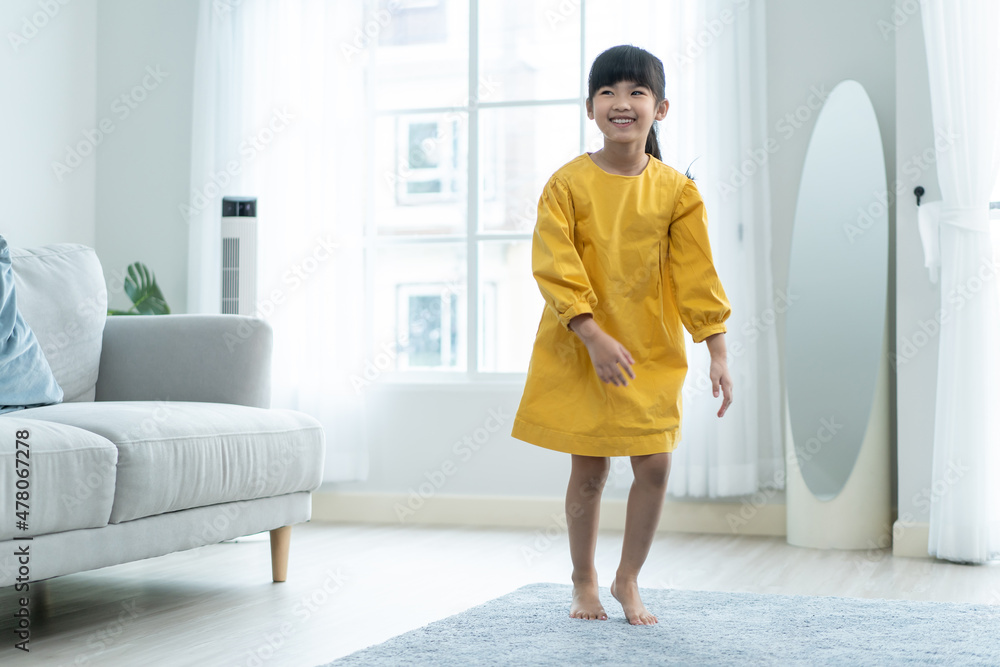 Portrait of Asian young girl kid playing alone in living room at home.