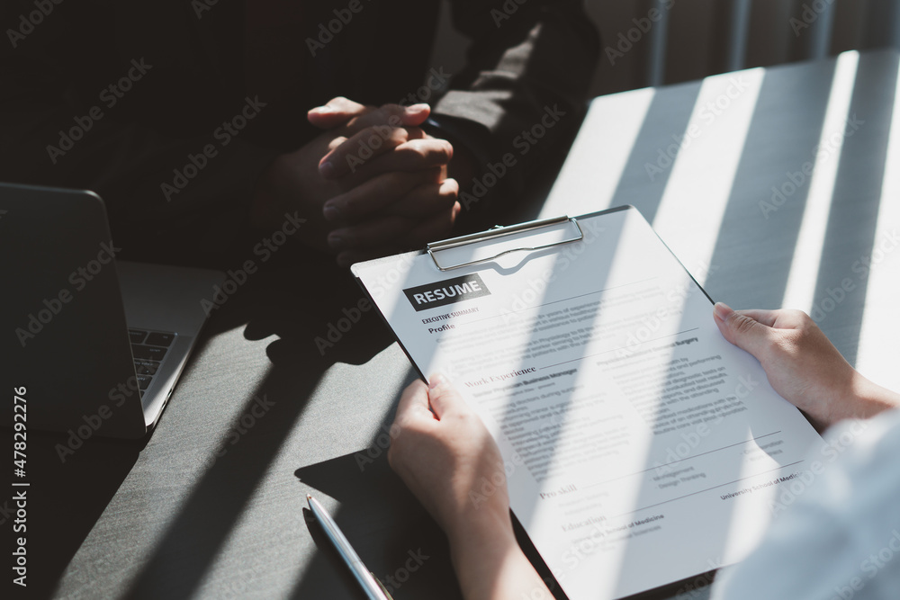 Executive reading a resume during a job interview and businessman Completing Application Form. Hirin