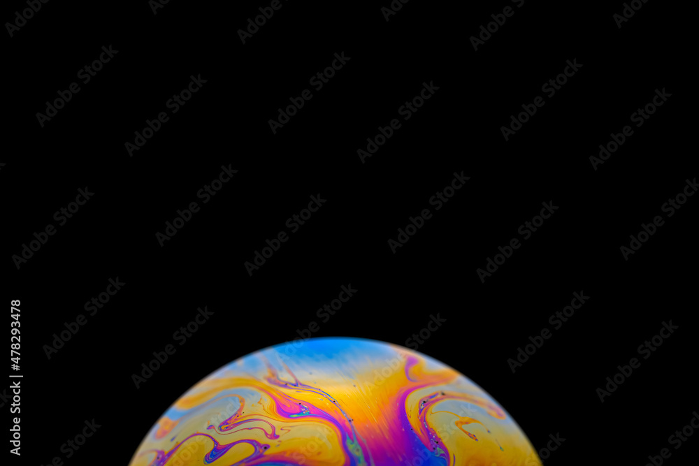 Soap bobble close-up. Multicolor psychedelic alien planet with an atmosphere in the darkness of the 