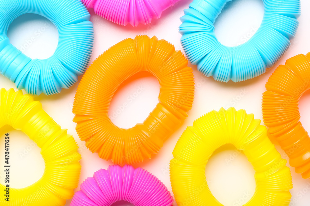 Different colorful Pop Tubes on white background