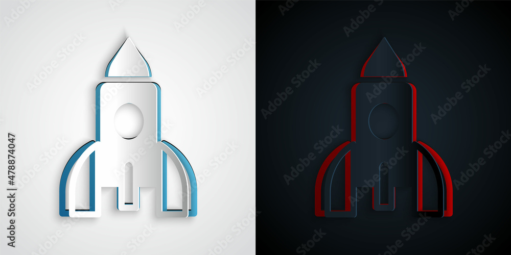 灰色和黑色背景上的剪纸火箭飞船玩具图标。太空旅行。纸艺术风格。