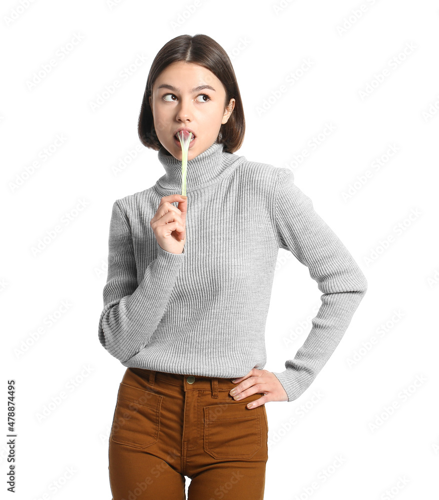 Funny young woman with chewing gum on white background