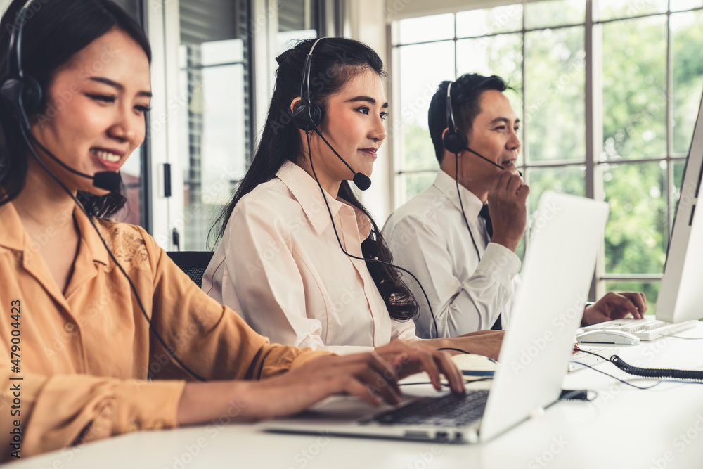 Business people wearing headset working actively in office . Call center, telemarketing, customer su