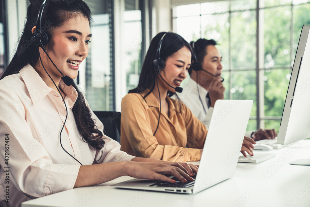 Business people wearing headset working actively in office . Call center, telemarketing, customer su