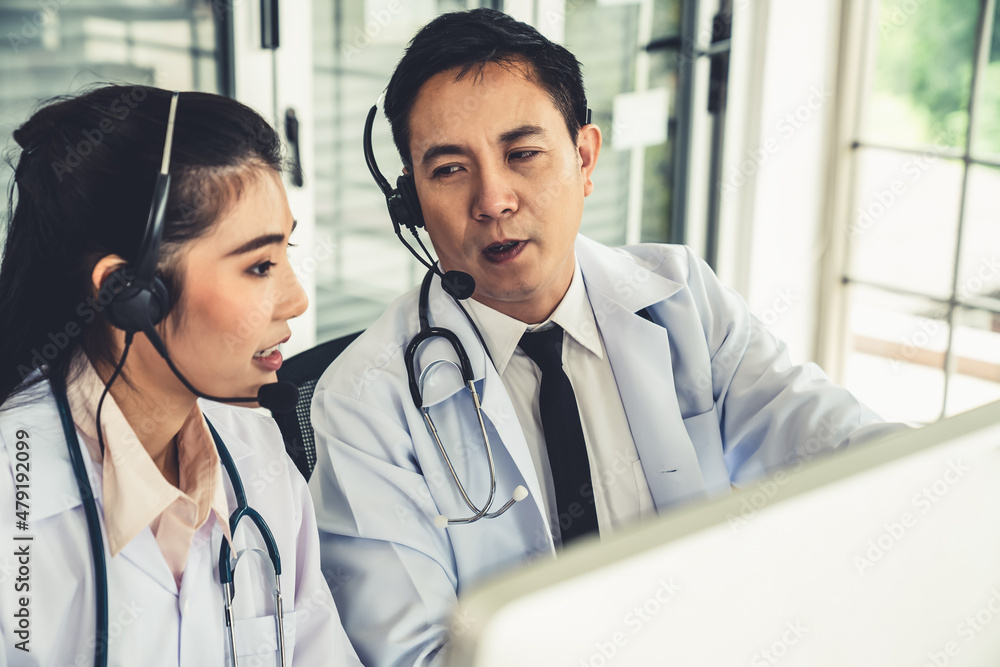 Doctor team wearing headset talking actively on video call in hospital clinic . Concept of telehealt