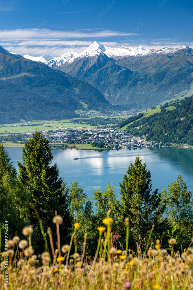 Ship sails over the idyllic lake Zell am See in a summer alpine landscape in the Salzburger Land, Ze