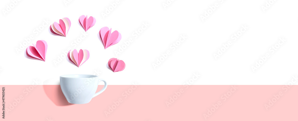 Coffee cup with paper craft hearts - flat lay