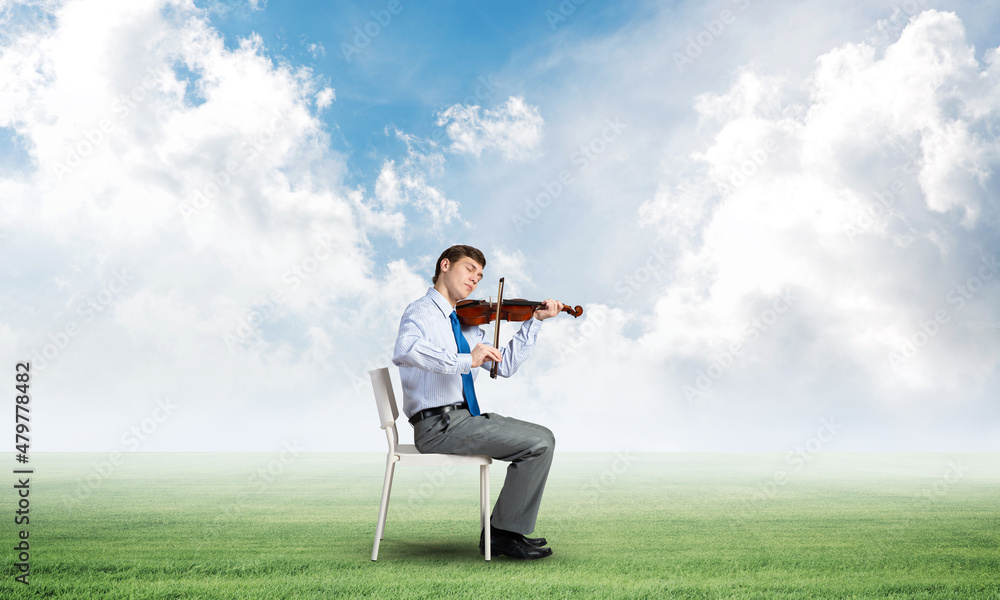 young businessman playing violin