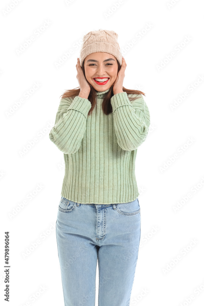 Pretty young woman in warm sweater on white background