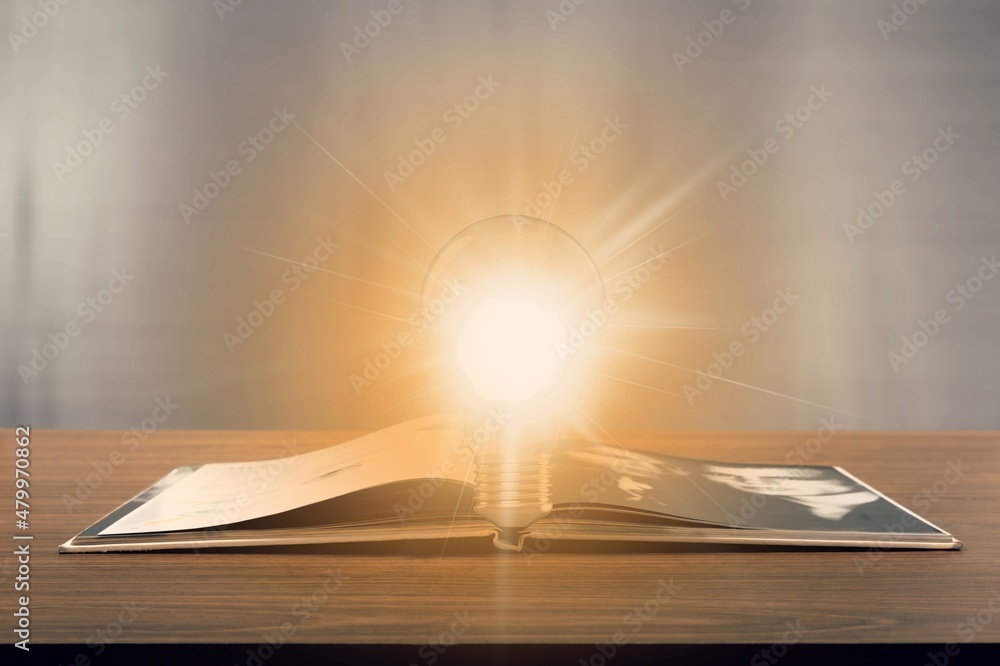 Bright lamp or glowing light bulb with book. Business success idea or solution concept. Thinking