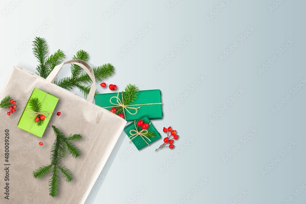 Christmas gift boxes in eco-friendly cotton bag with fir branches. Christmas zero waste.