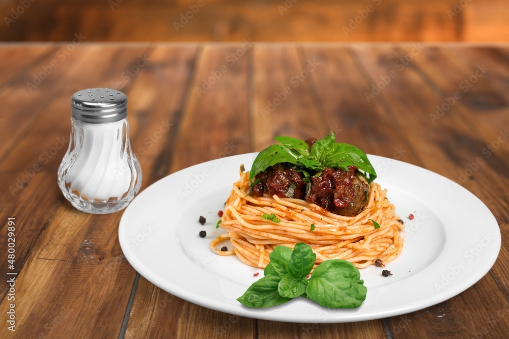 spaghetti pasta with meatballs and sauce, basil, cheese