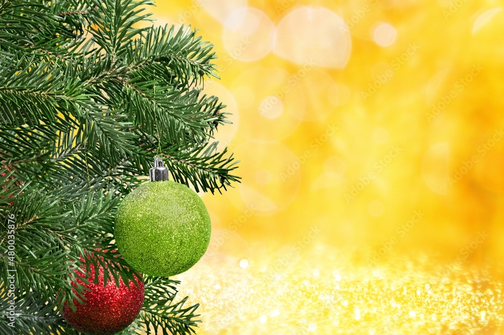 Christmas ball on the Christmas tree surrounded by festive lights.