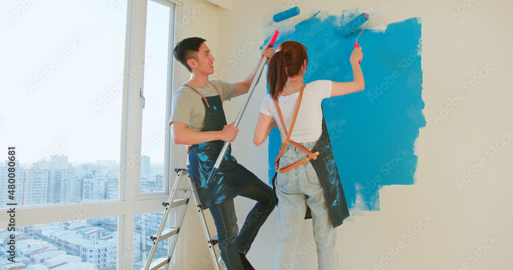 couple painting wall