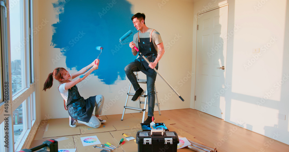 couple painting wall