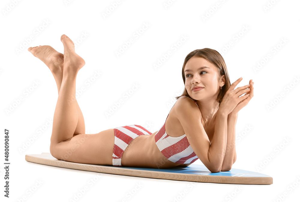 Beautiful young woman with surfboard on white background