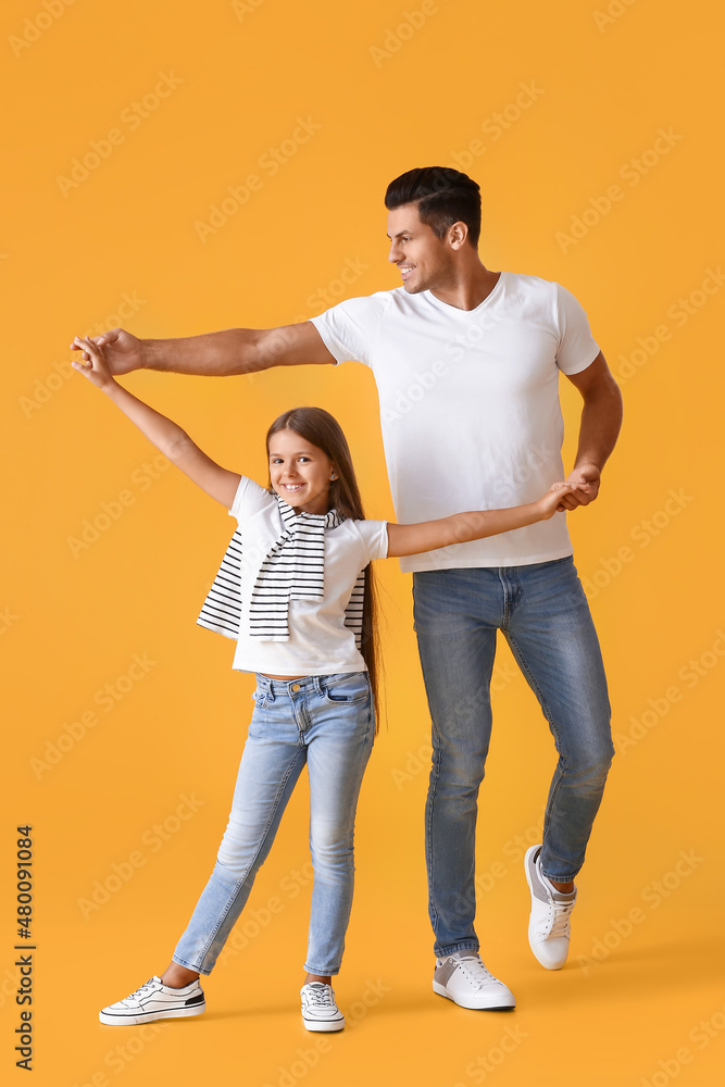 Happy dancing man and his daughter on color background