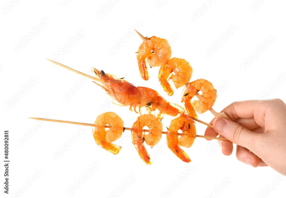 Woman holding grilled shrimp skewers on white background