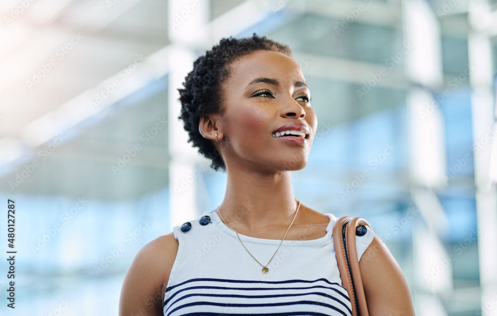 The future looks bright ahead. Cropped shot of an attractive young businesswoman looking thoughtful 