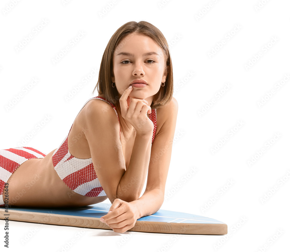 Beautiful young woman with surfboard on white background