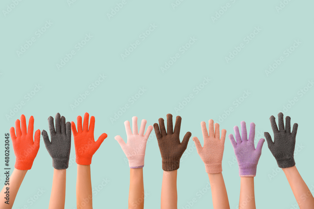 Women in warm gloves on blue background