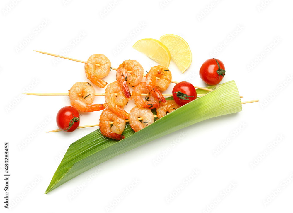 Grilled shrimp skewers with lemon and tomatoes on white background