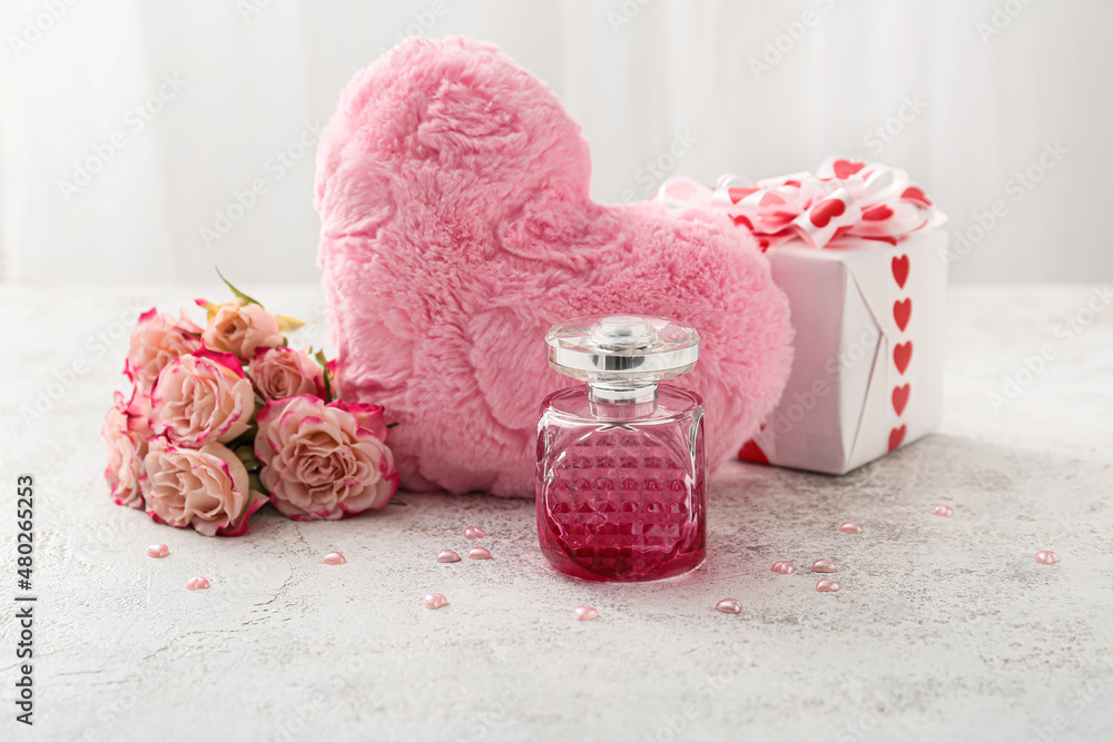 Perfume and roses for Valentines day on light background