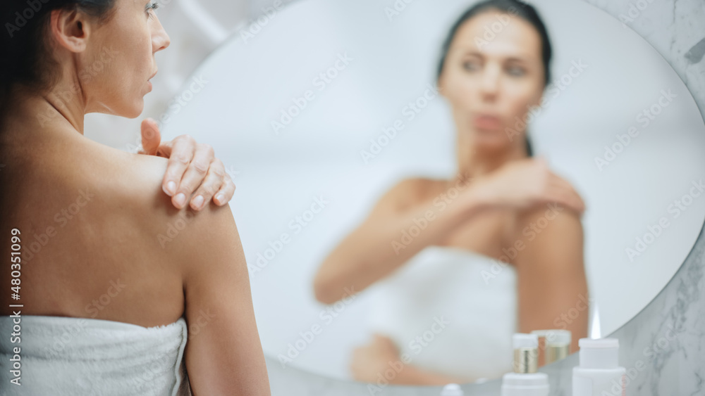 Beautiful Caucasian Woman Applies Body Cream to Her Perfect Shoulder, Making the Skin Soft, Looks in