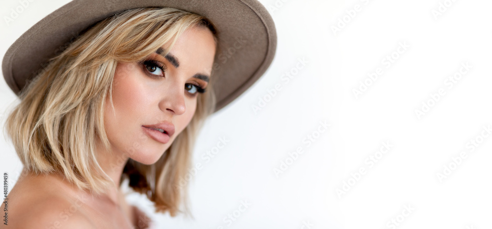 Pretty face woman in hat posing isolated with copy space