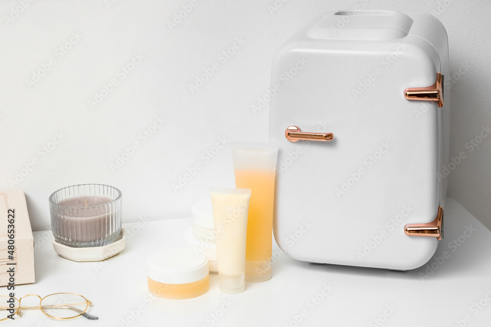 Small cosmetic refrigerator on table in room