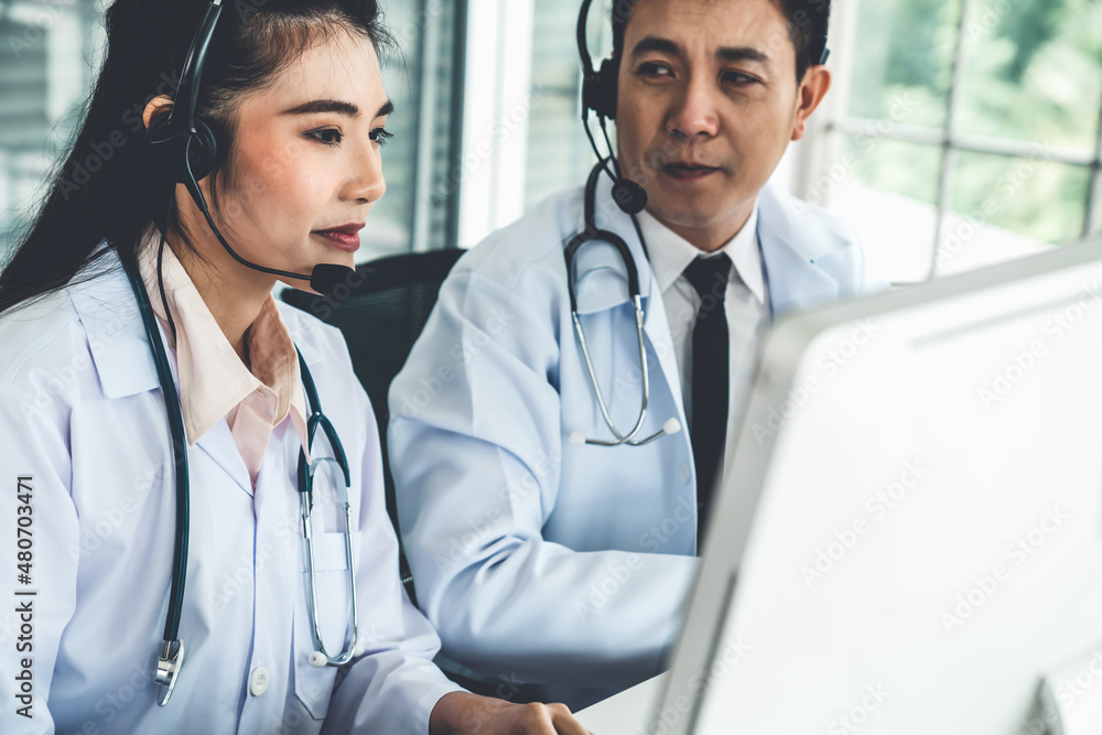 Doctor team wearing headset talking actively on video call in hospital clinic . Concept of telehealt