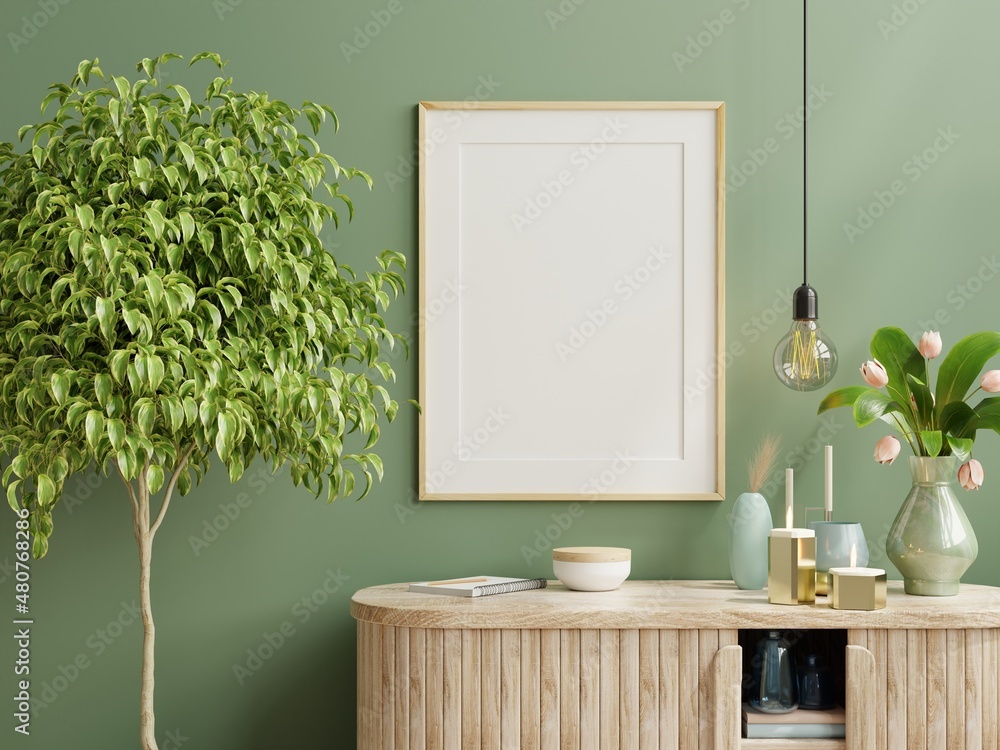 Mock up photo frame green wall mounted on the wooden cabinet with beautiful plants.