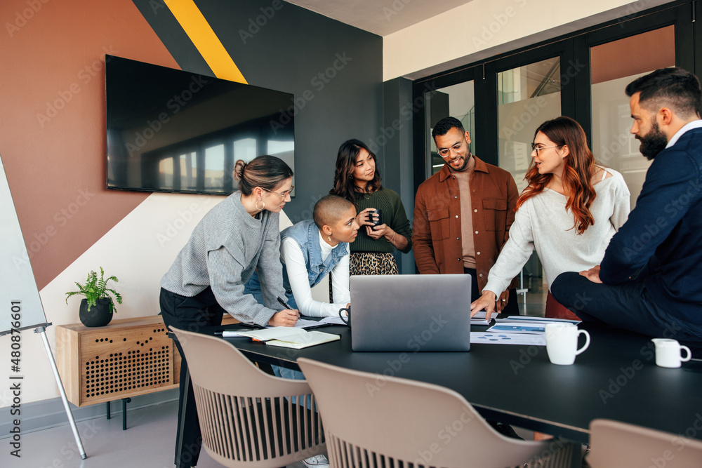 Diverse businesspeople discussing some reports in a boardroom