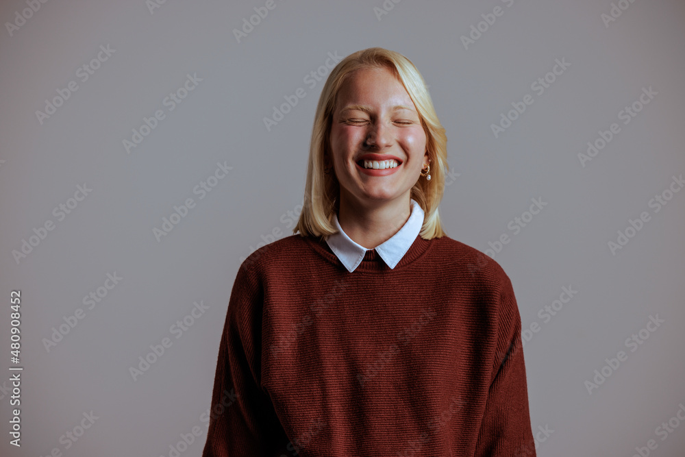 Smiling adult woman, happily showing off her optimistic attitude.