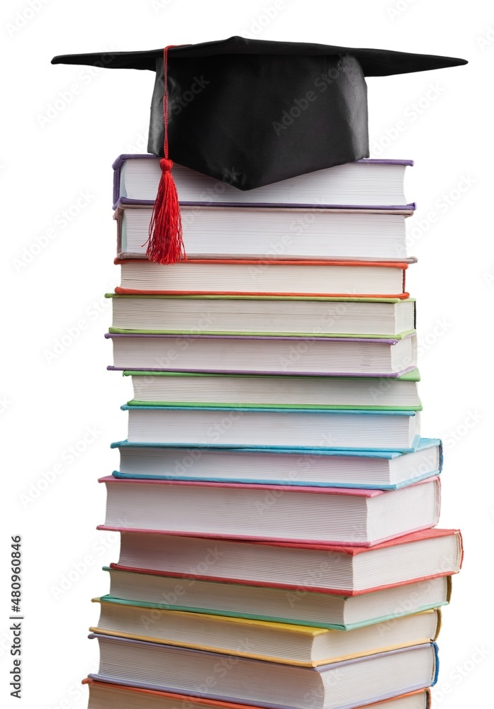 Stack school books with a black graduation hat