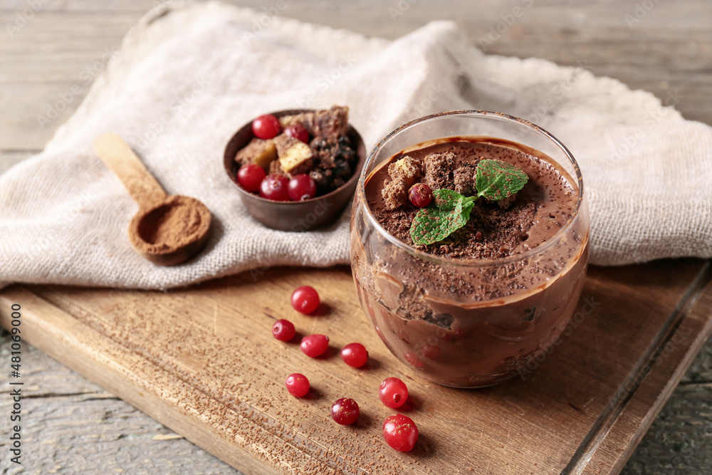 Glass of sweet cocoa dessert on table