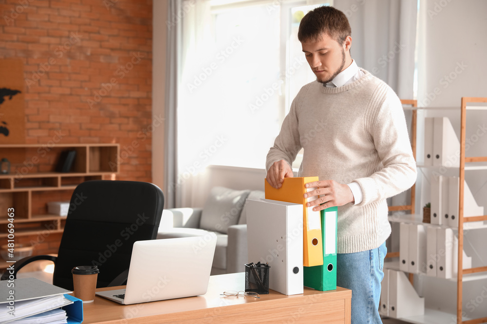 Young man working with documents in office