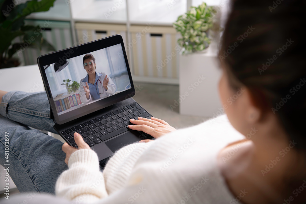 Young Asian woman sit at home have video call with doctor use wireless internet connection on tablet