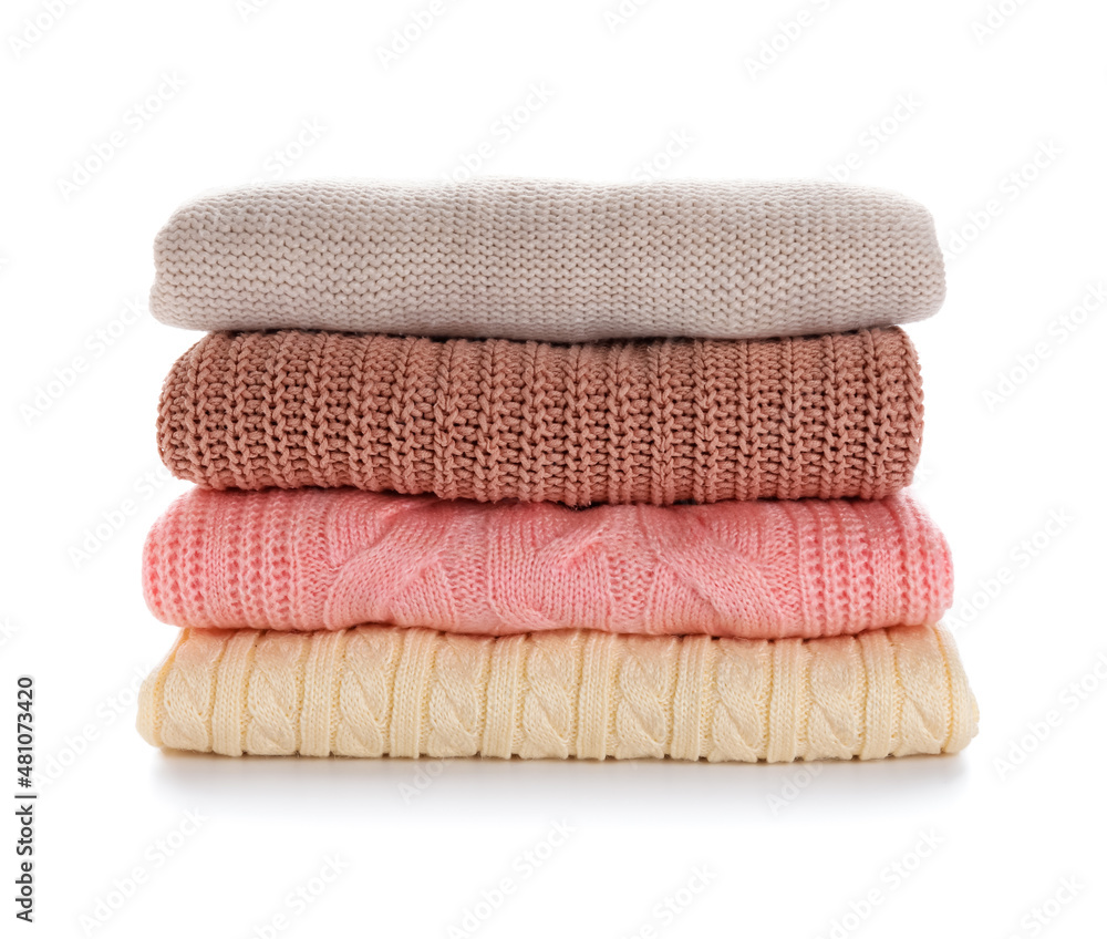 Stylish baby sweaters on white background