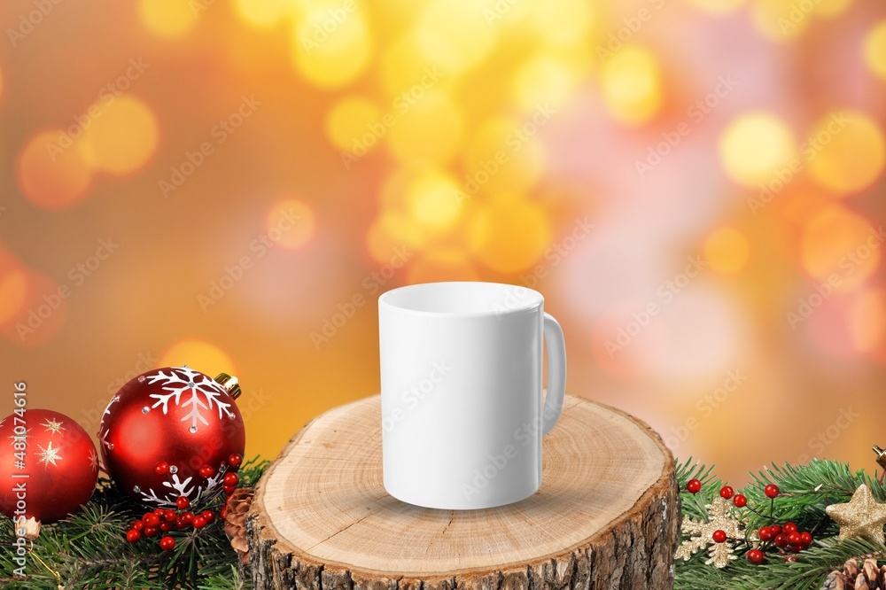 A mug on a wooden background with bright lights in the background. New Year and Christmas.