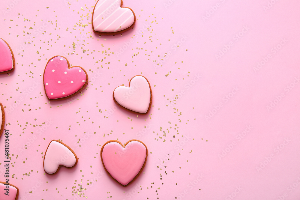 Tasty heart shaped cookies on pink background