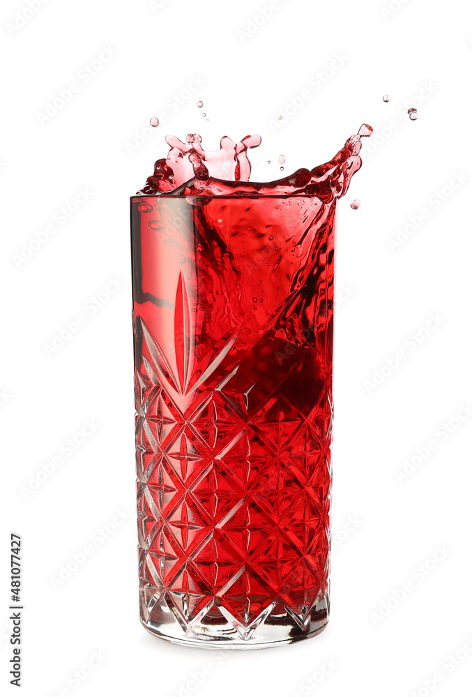 Glass of tasty pomegranate juice with splashes on white background