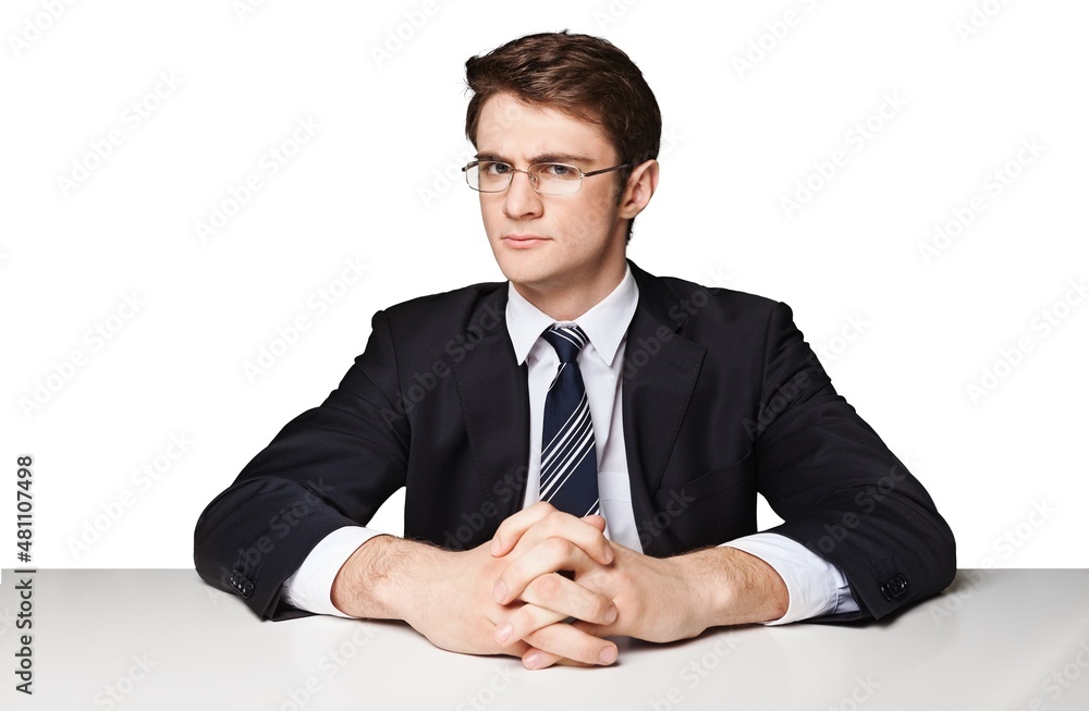 serious businessman sitting at office desk