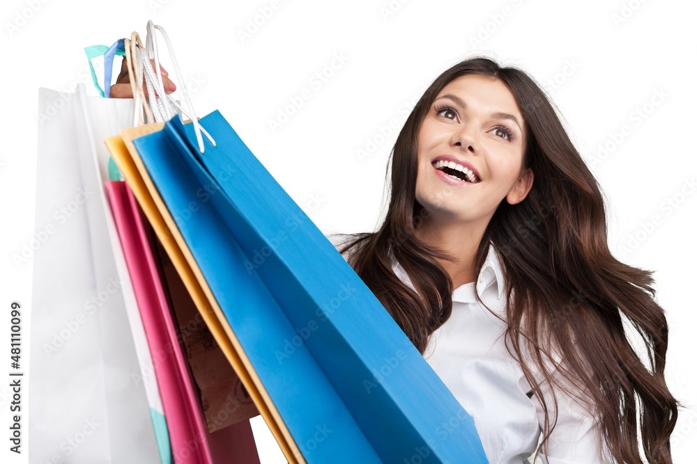 Young smiling woman holding shopping bags and a credit card