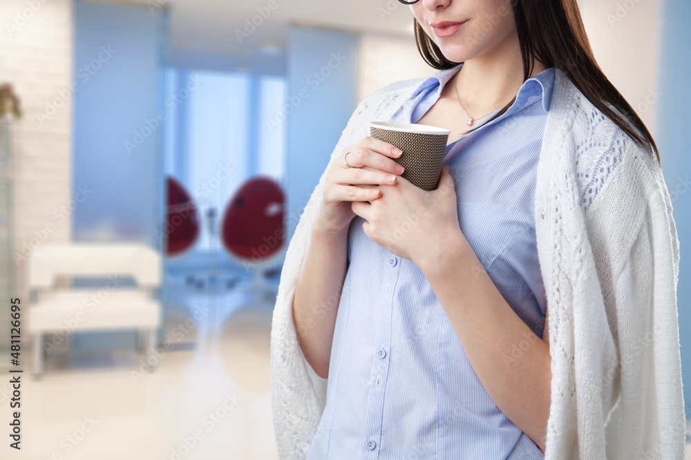 Female hands hold a mockup mug. For your logo and design.