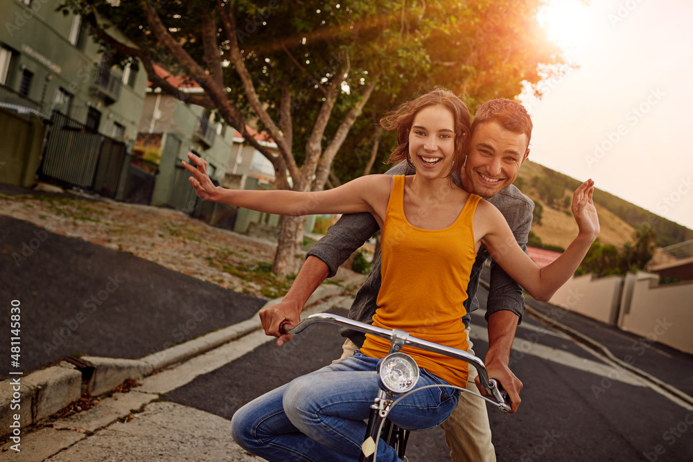 Love makes life a beautiful ride. Shot of a happy young couple enjoying a bicycle ride together.