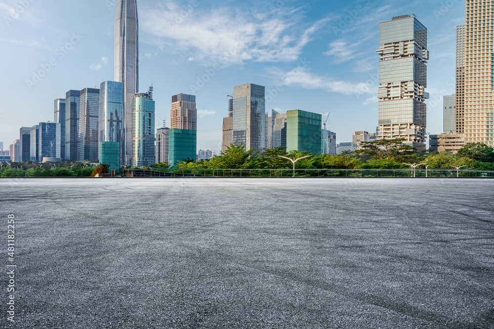 Asphalt road and city skyline with modern commercial buildings in Shenzhen, China.