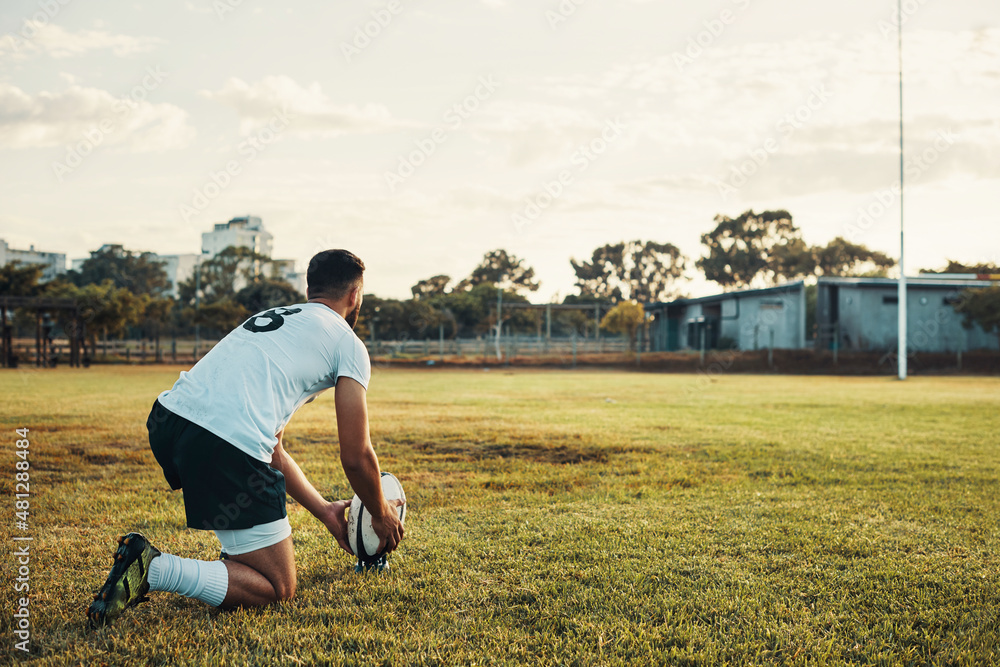 Kicking is what he does best. Full length shot of a handsome young rugby player preparing for a kick