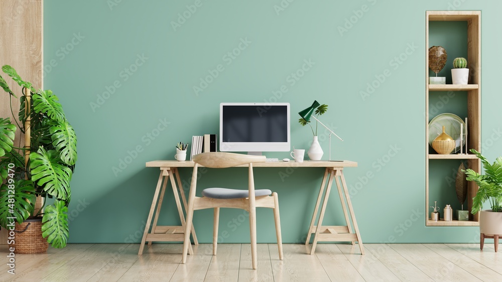 Green office room with a pastel background.