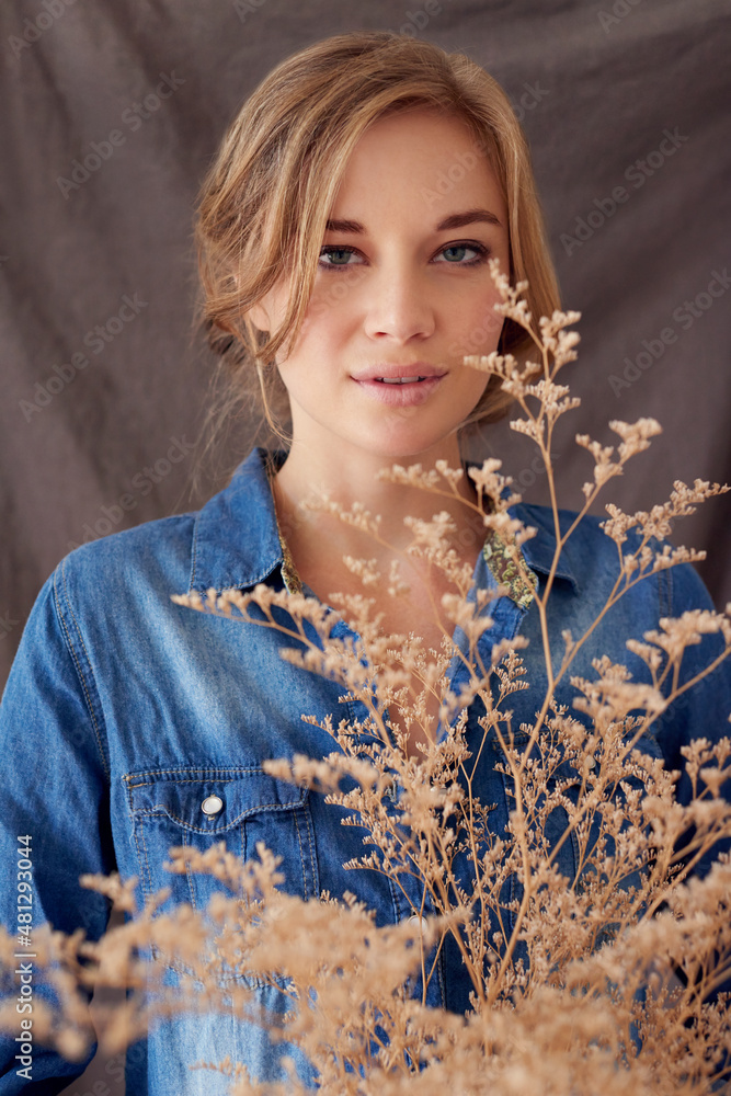 You can plant a dream. Shot of a beautiful young woman holding a dried out plant.